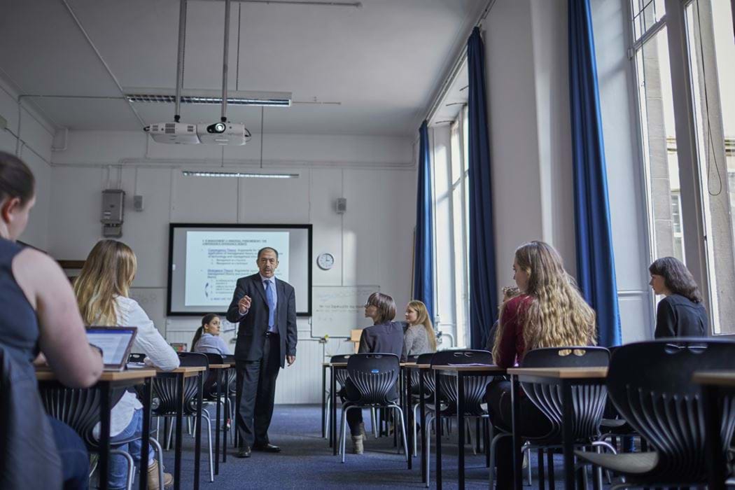 Classroom environment - lecturer standing - students sitting listening