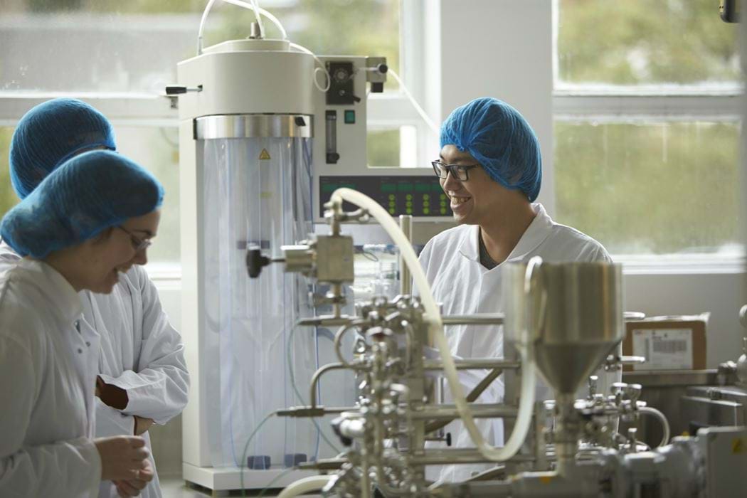 Three people working in a food laboratory