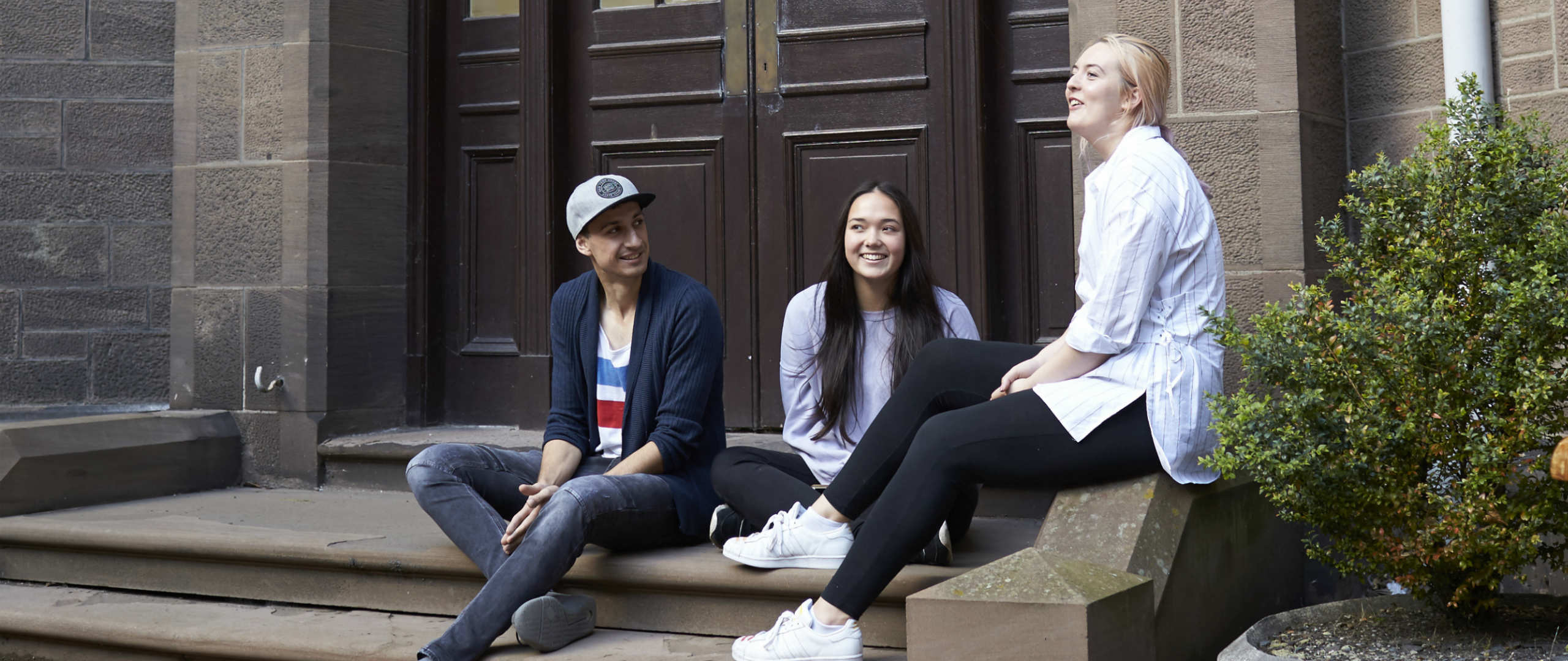 Students outside enjoying the sun in the Abertay Quad