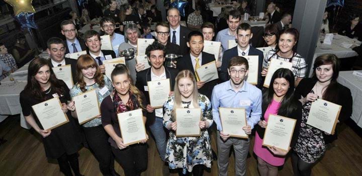 Group of people holding certificates