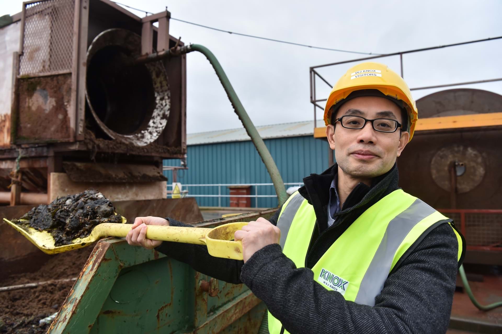 Boon Seang Chung of Abertay University's School of Applied Sciences shovelling waste into a skip