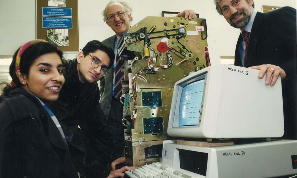 Two students, female and male, with two male lecturers in the mechanical engineering department of Dundee Institute of Technology (Abertay University) with a built ATM machine (inner parts only) and desktop computer. 