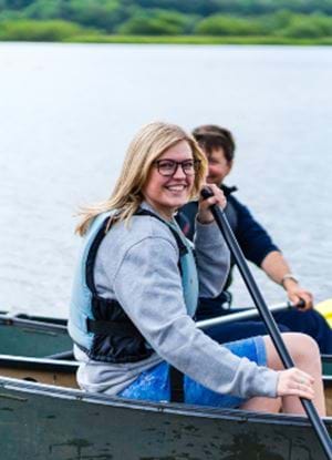 Posed photo of Abertay Alumni Erin Scott in a boat