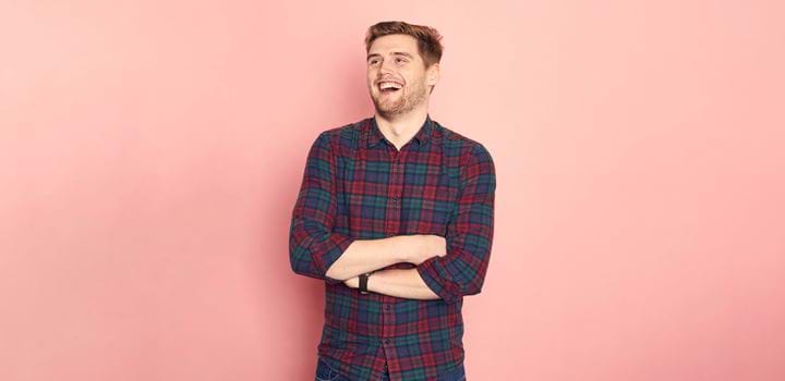 An Abertay Student on a pink coloured background