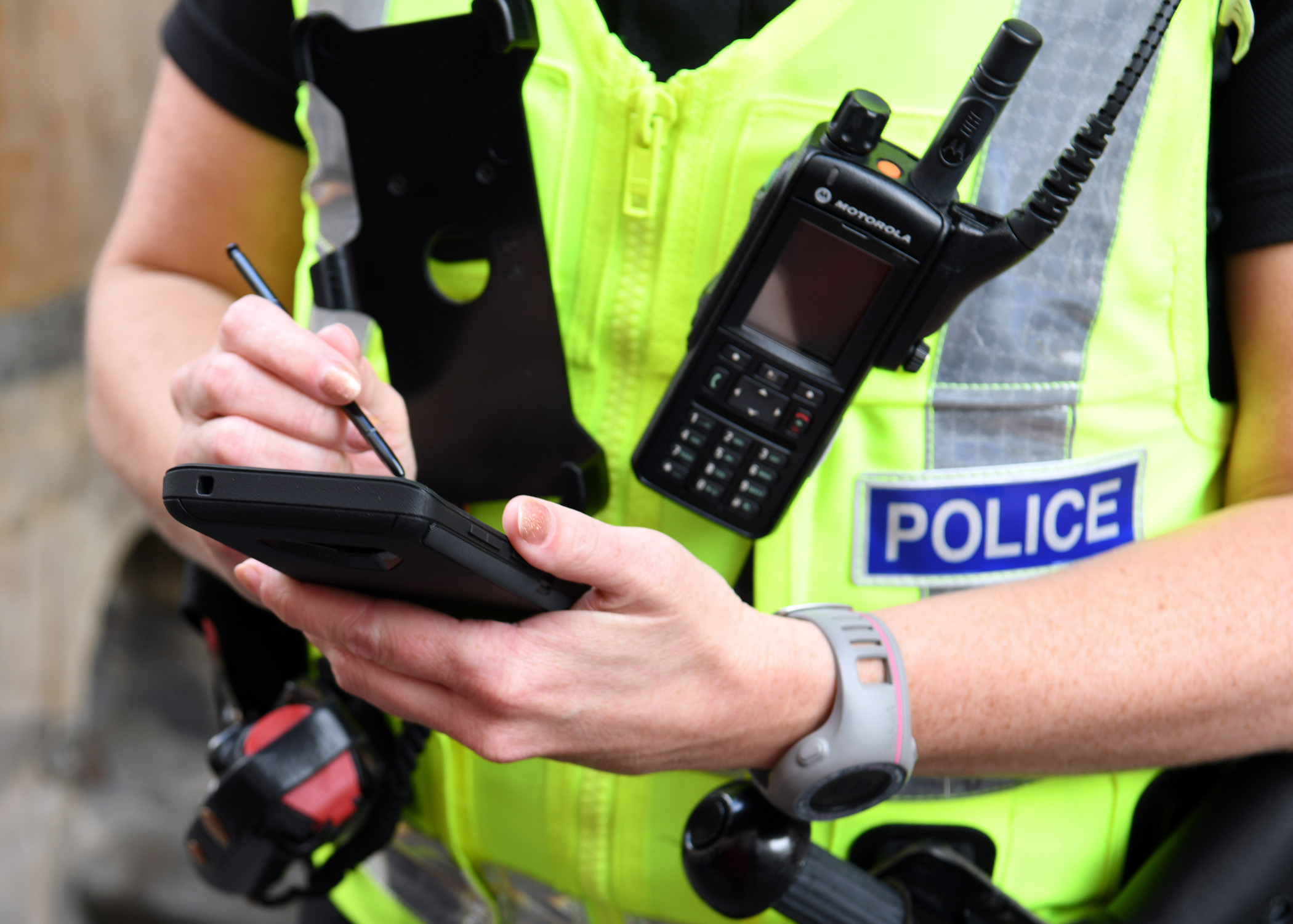 A police officer taking notes on a digital tablet