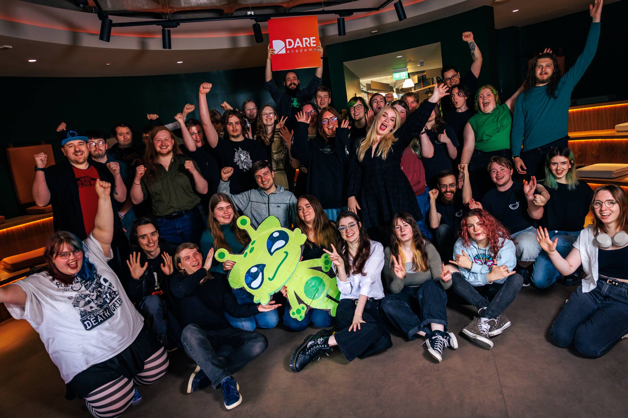 Dare Academy 2025 teams celebrate, gathered in a group on Abertay University's campus