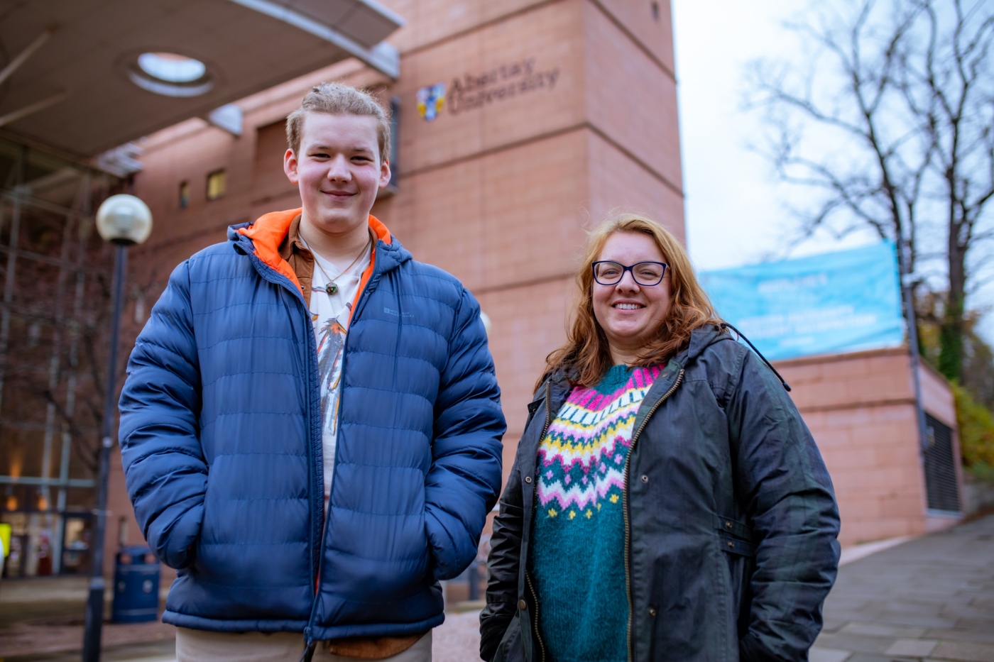 A student and his parent outside Abertay library 