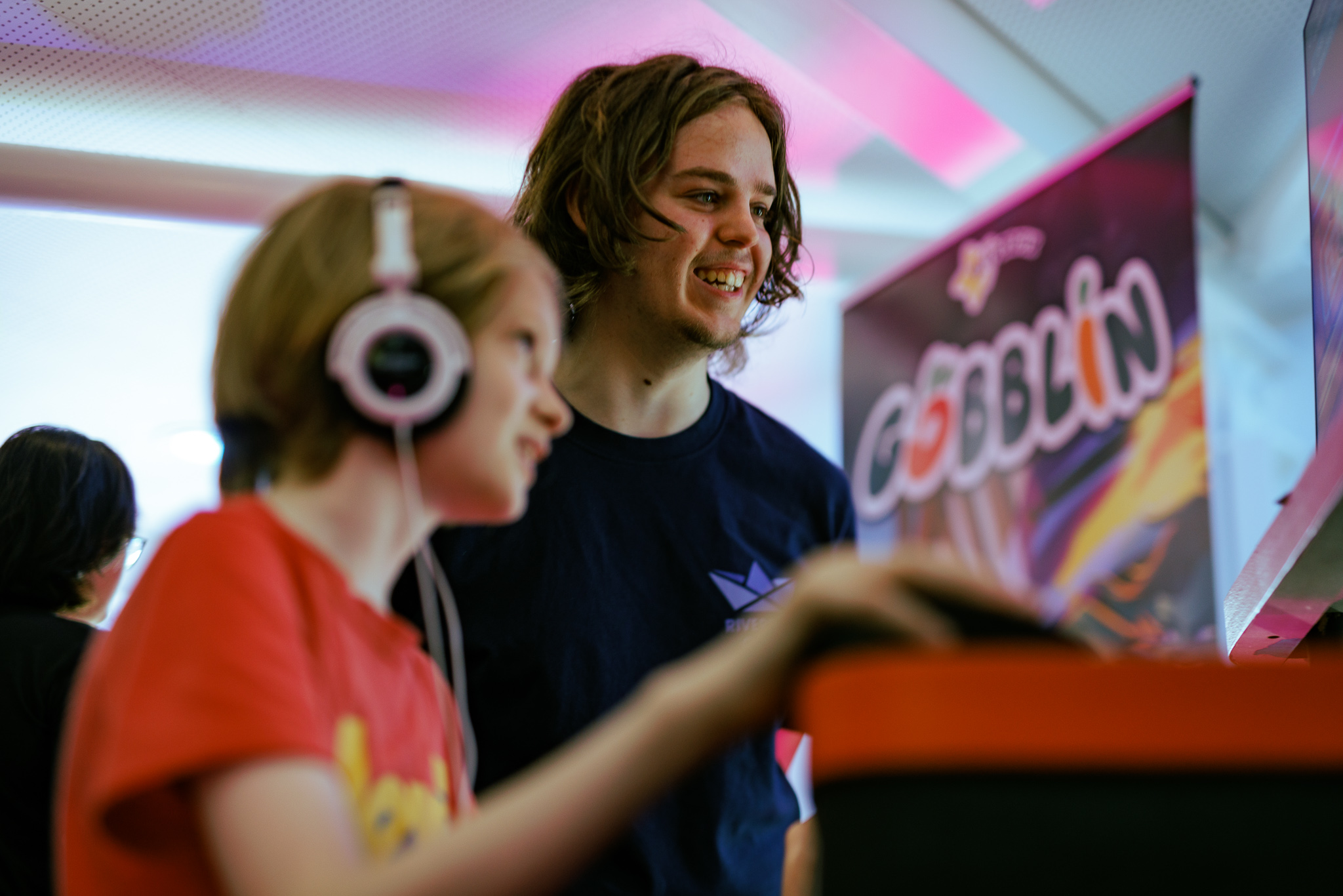 A student showing a young person one of the showcase games.