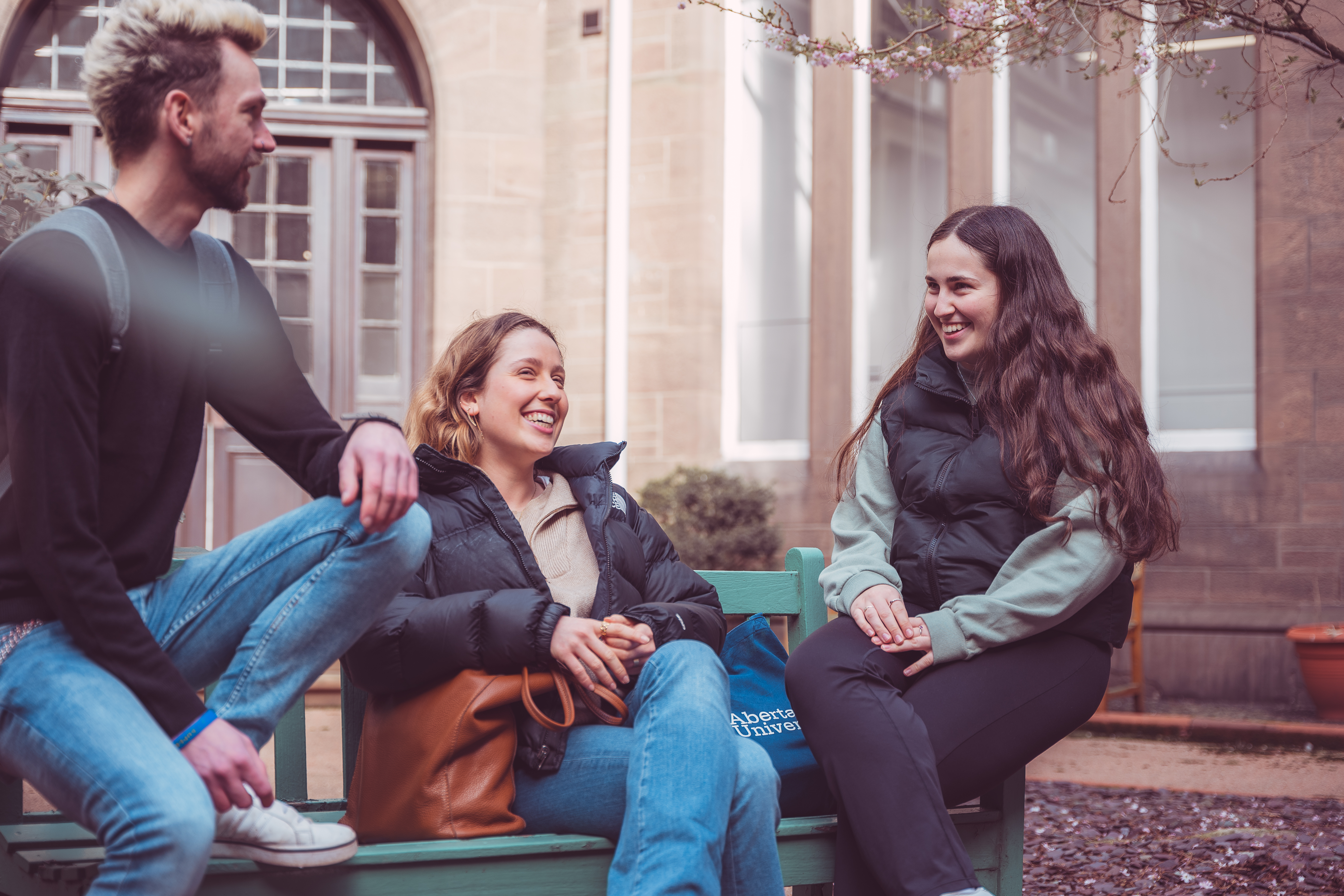 Three students chatting outside 