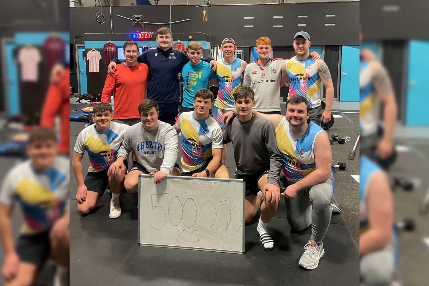 The image shows the rugby team holding a sign saying saying 500,000 kilos reached