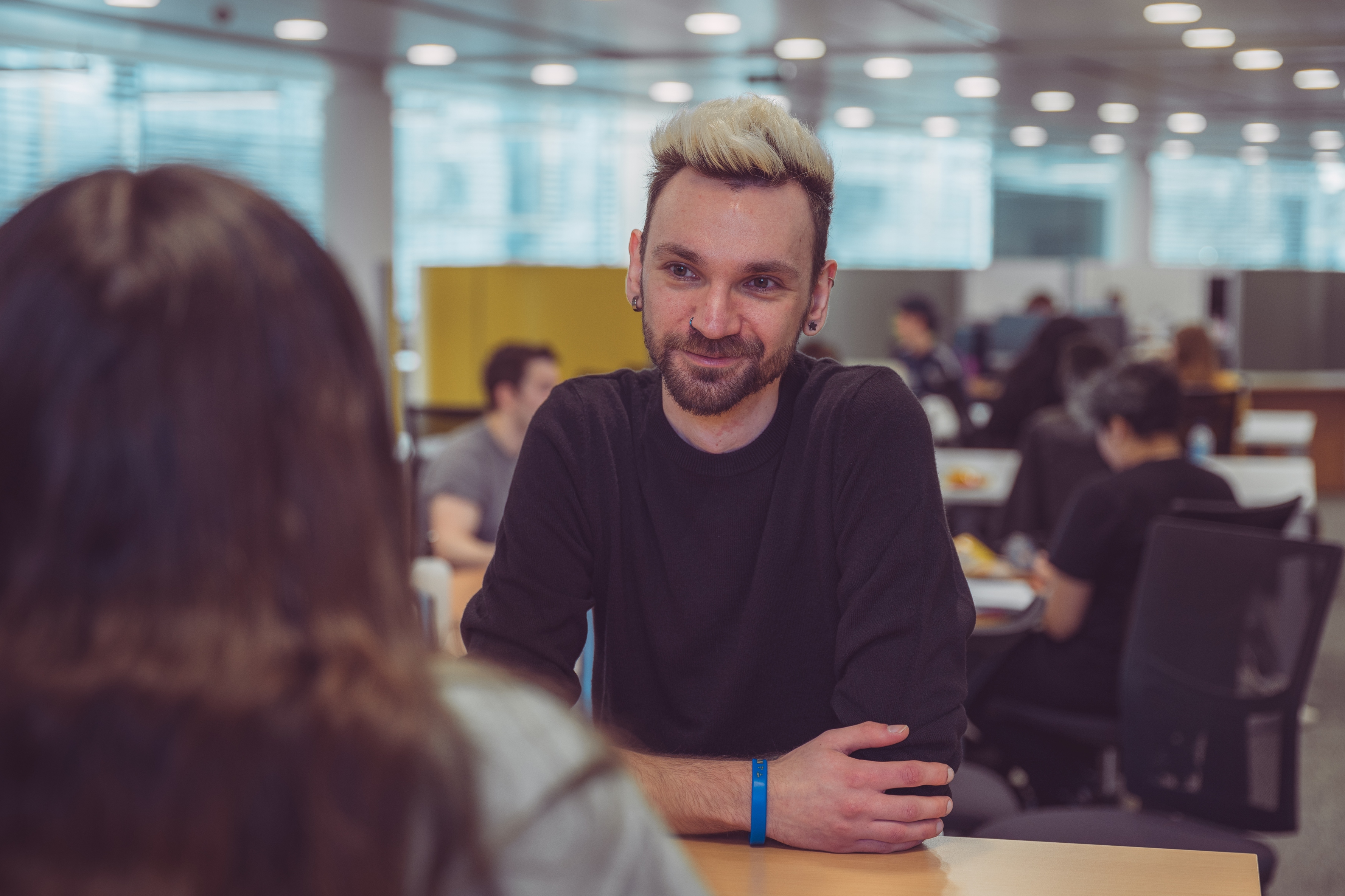 Two students chatting in a classroom