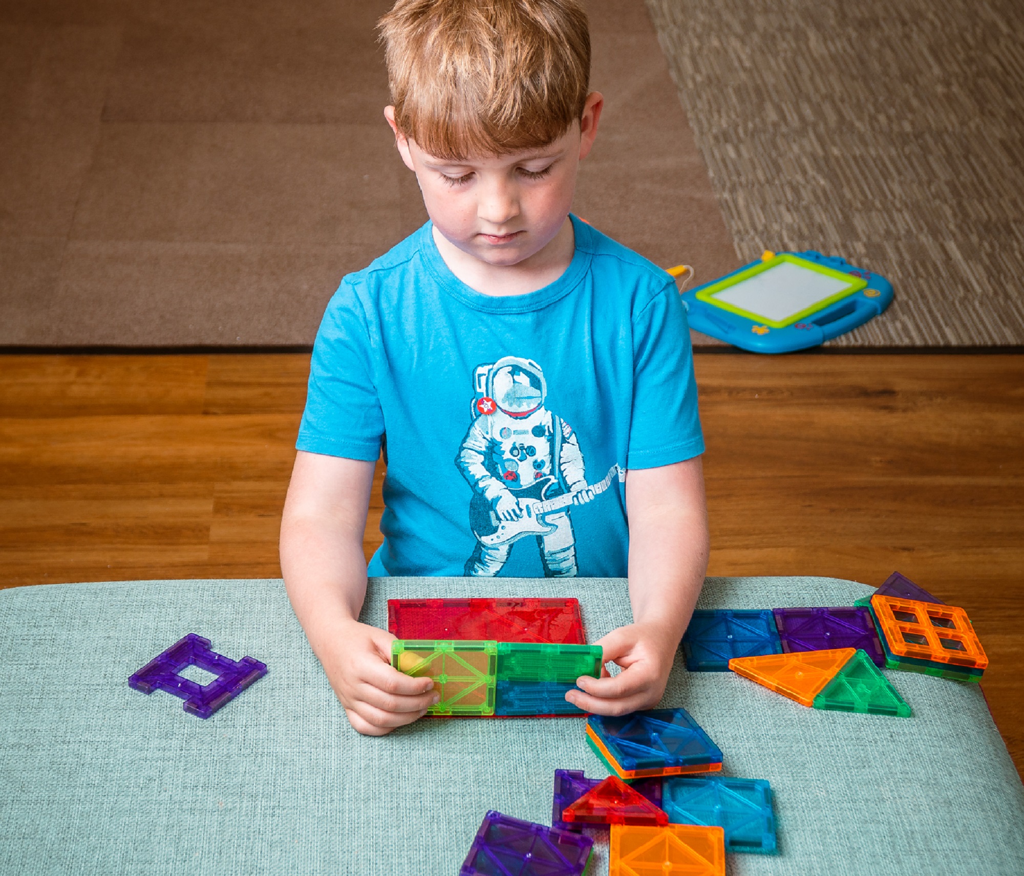 Boy with plastic shapes experiment